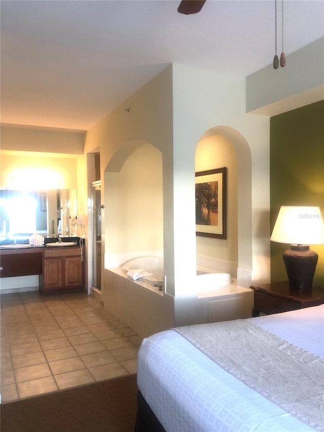 bedroom with light tile floors, ceiling fan, and sink