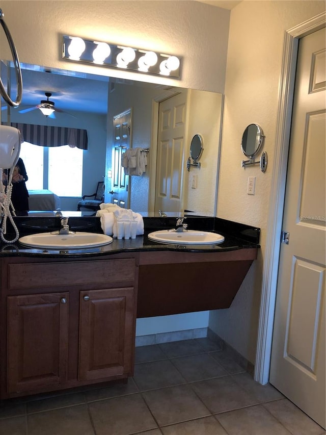 bathroom with double sink vanity, tile flooring, and ceiling fan