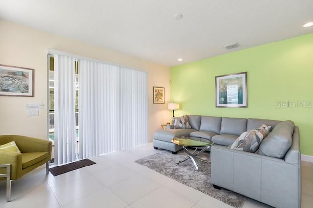 tiled living room with visible vents and recessed lighting