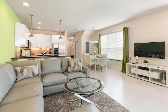 living area featuring recessed lighting and baseboards