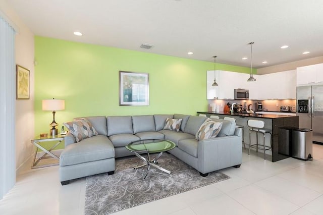 living room featuring recessed lighting, visible vents, and light tile patterned flooring