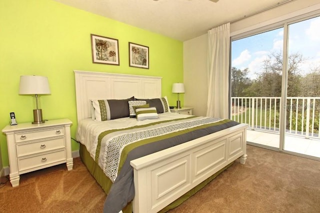 bedroom featuring access to exterior, dark carpet, and multiple windows