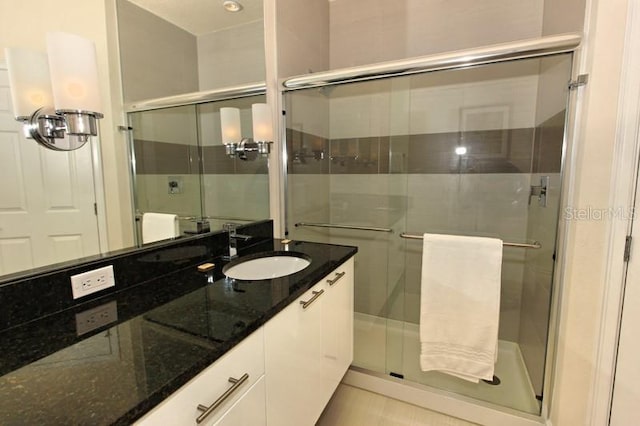 bathroom featuring a stall shower and vanity