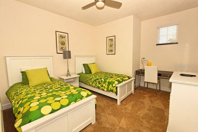 carpeted bedroom featuring baseboards and ceiling fan