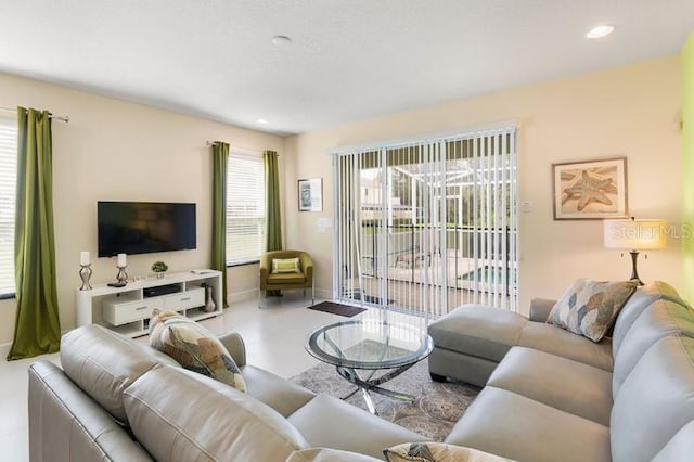 living room featuring a wealth of natural light, recessed lighting, and baseboards