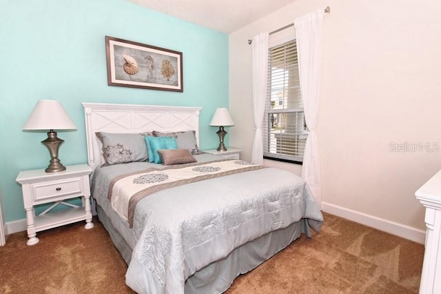 bedroom featuring carpet flooring and baseboards