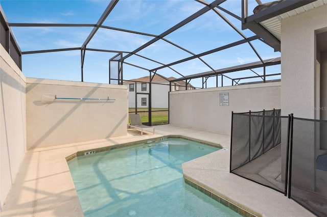 view of swimming pool with a patio and a lanai