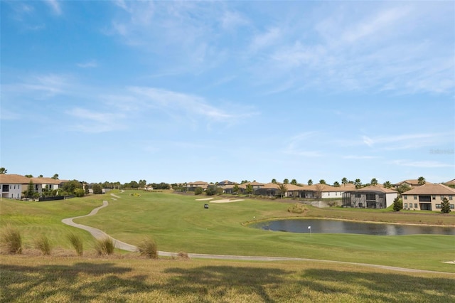 surrounding community featuring a lawn and a water view