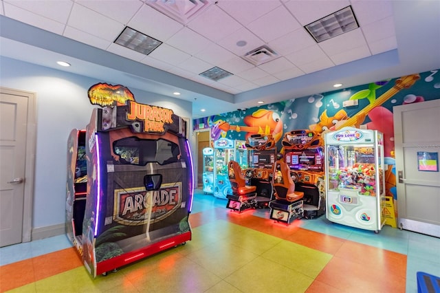 playroom featuring a raised ceiling, light tile floors, and a drop ceiling