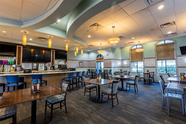 dining space with a drop ceiling