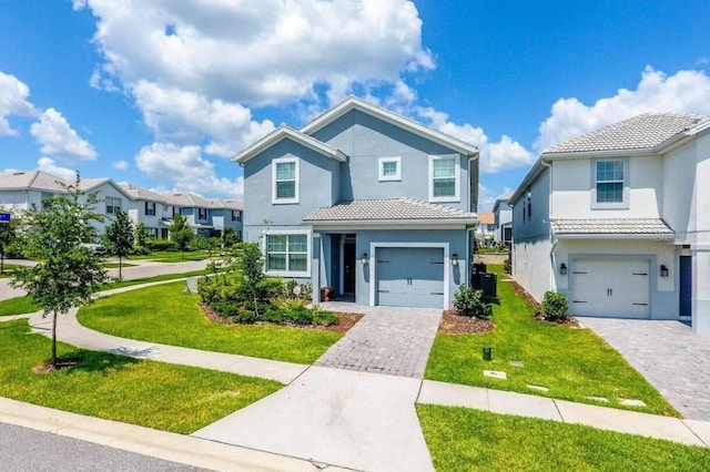 view of property with a front yard and a garage