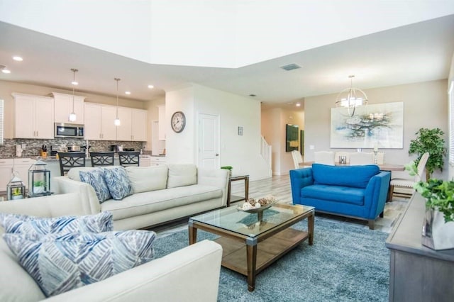 living room featuring a chandelier and hardwood / wood-style flooring