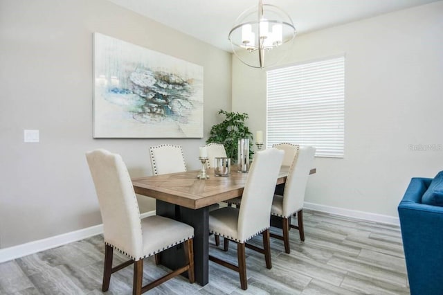 dining space featuring an inviting chandelier, light hardwood / wood-style floors, and a wealth of natural light