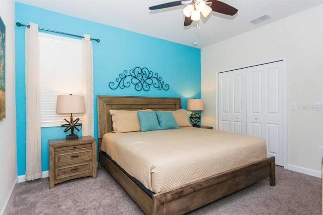 carpeted bedroom featuring a closet and ceiling fan