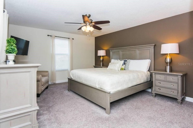 bedroom with ceiling fan and light colored carpet