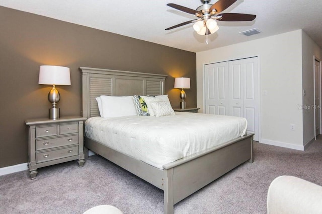 bedroom featuring light carpet, a closet, and ceiling fan