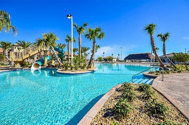 view of swimming pool with a water slide