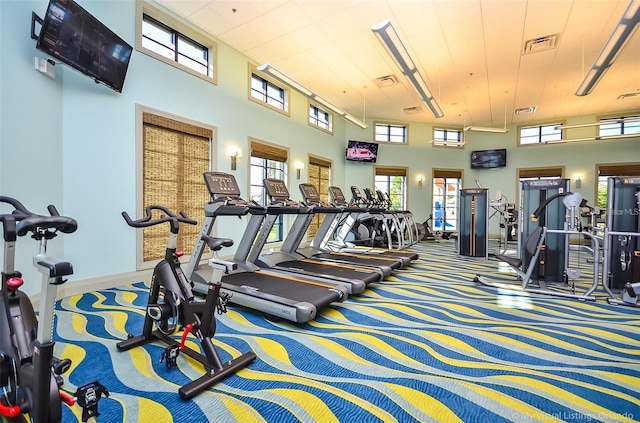 workout area featuring a high ceiling and carpet