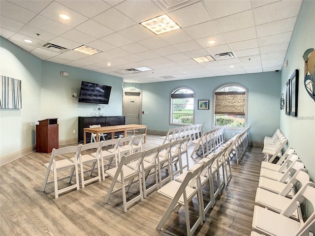 interior space with a paneled ceiling and dark wood-type flooring