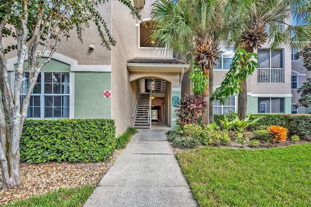 doorway to property featuring stucco siding