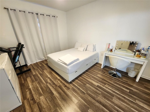 bedroom featuring baseboards and dark wood finished floors