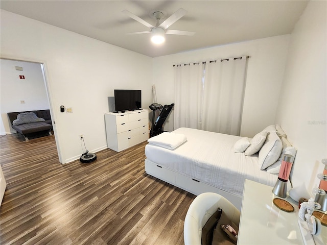 bedroom with a ceiling fan, baseboards, and dark wood-style flooring