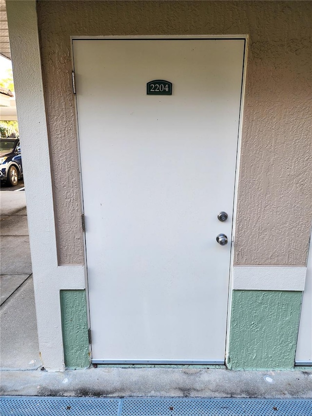 doorway to property with stucco siding