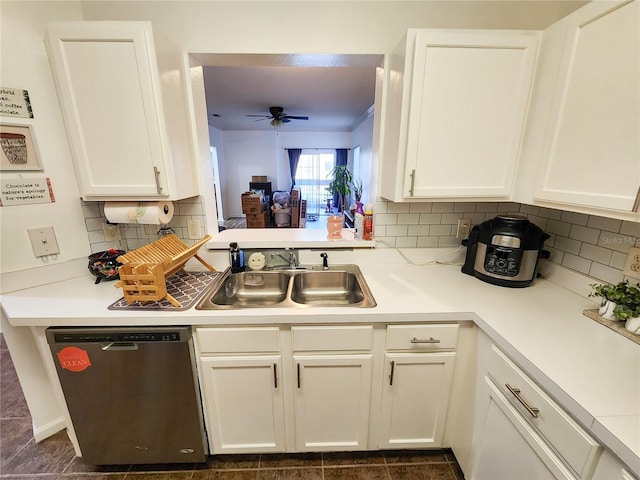 kitchen with dishwasher, light countertops, a sink, and white cabinetry