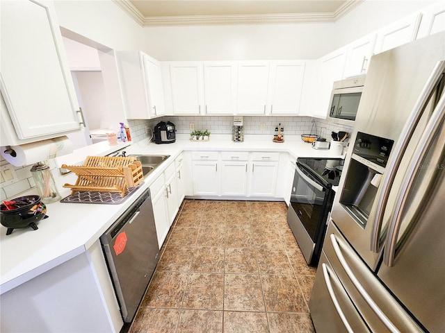 kitchen with appliances with stainless steel finishes, light countertops, crown molding, and white cabinetry