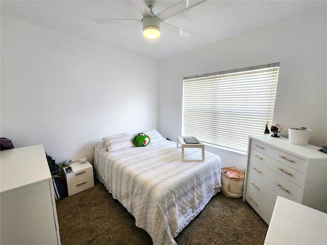 bedroom featuring dark carpet and a ceiling fan