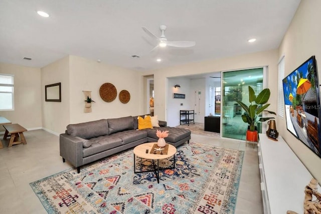 living room featuring light tile flooring and ceiling fan