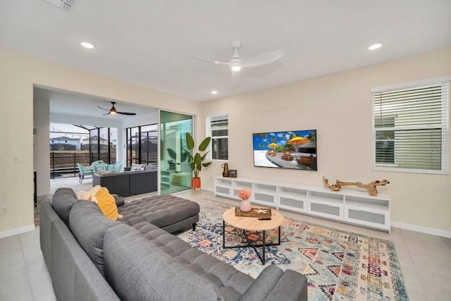 tiled living room with a healthy amount of sunlight and ceiling fan