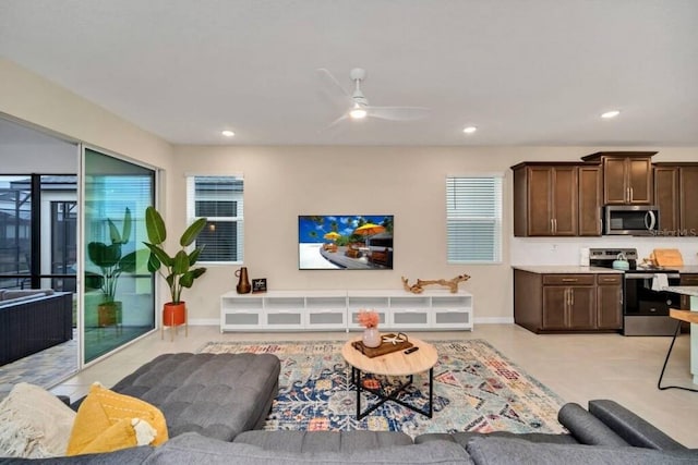 tiled living room featuring ceiling fan