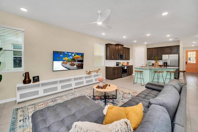 tiled living room featuring ceiling fan