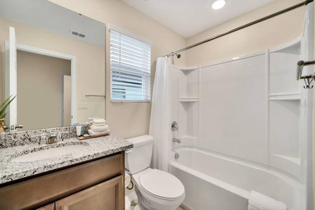 full bathroom with shower / bath combination with curtain, toilet, and vanity