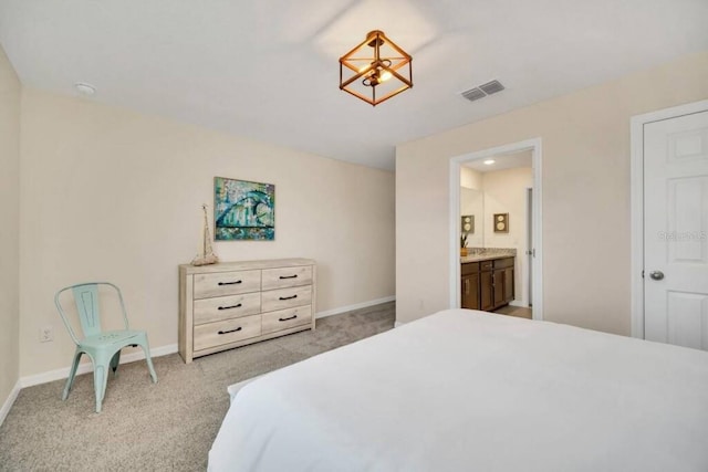 carpeted bedroom with ensuite bathroom