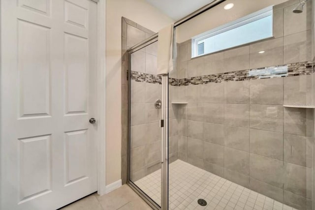 bathroom with walk in shower and tile flooring