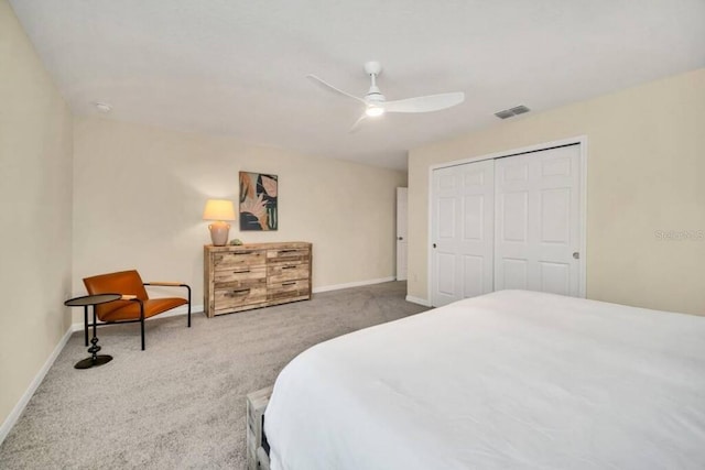 carpeted bedroom featuring a closet and ceiling fan