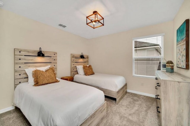 carpeted bedroom featuring a chandelier