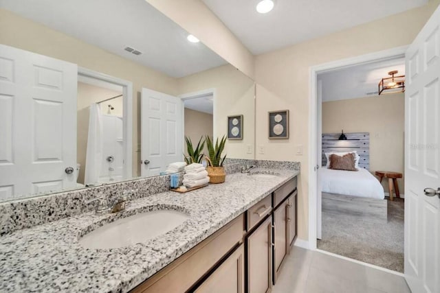 bathroom with double sink vanity and tile flooring