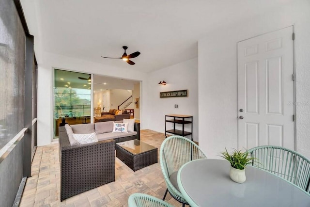 sunroom / solarium featuring ceiling fan