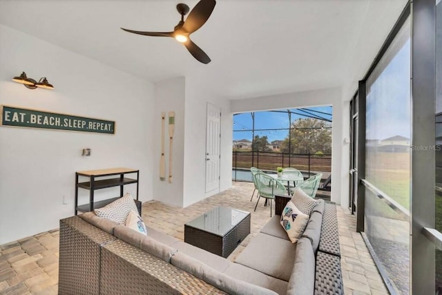 tiled living room featuring ceiling fan