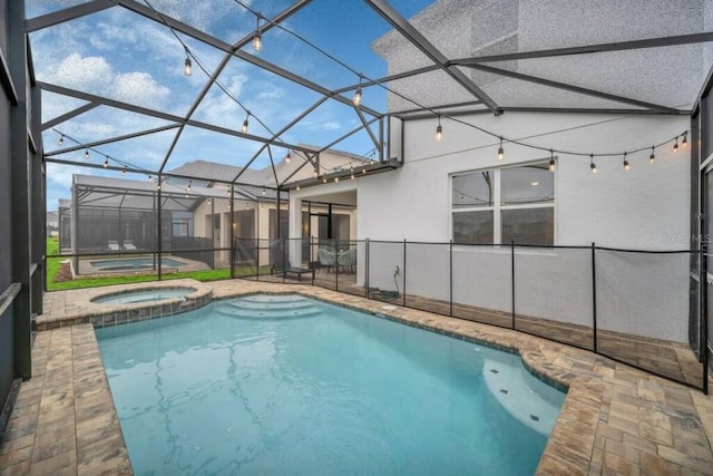 view of pool featuring an in ground hot tub and a lanai