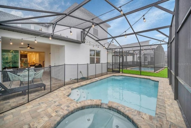 view of swimming pool with an outdoor hot tub, a patio, ceiling fan, and a lanai