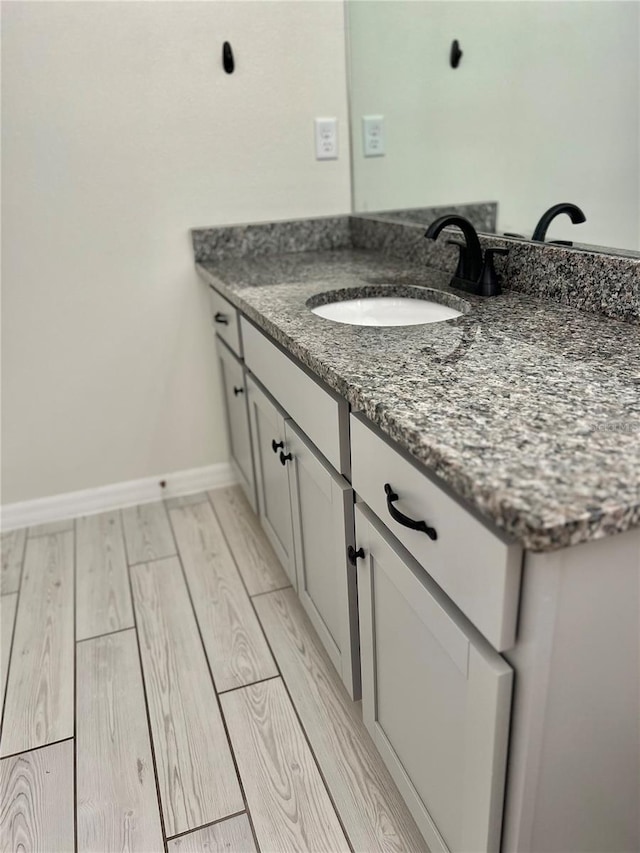 bathroom with vanity and wood-type flooring