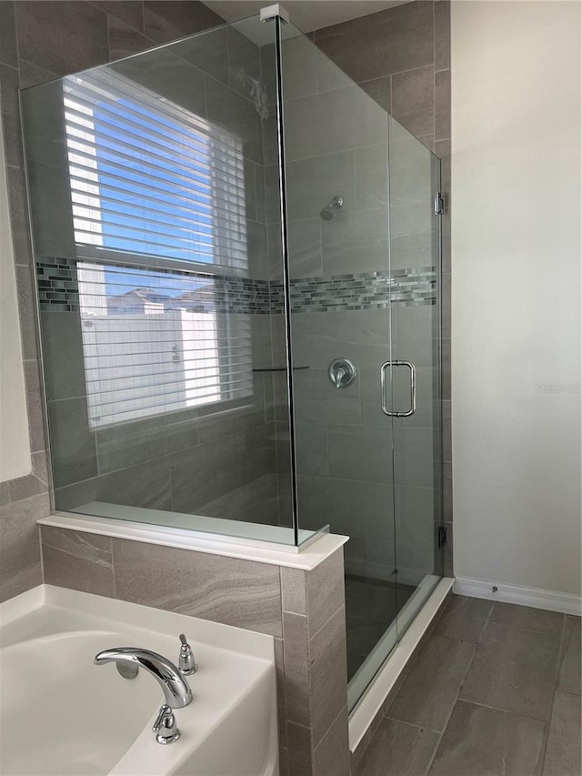 bathroom with separate shower and tub