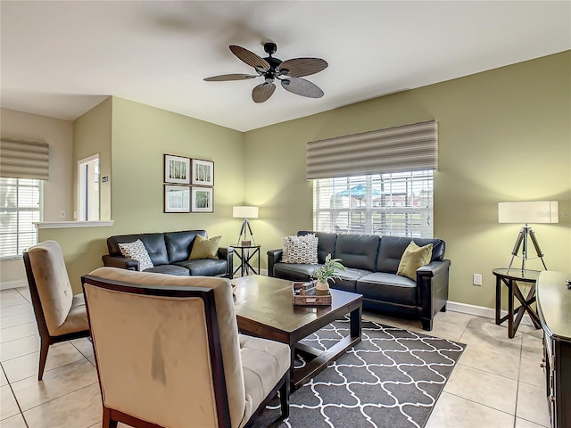 living room with light tile floors, plenty of natural light, and ceiling fan