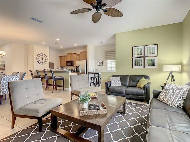 tiled living room with ceiling fan