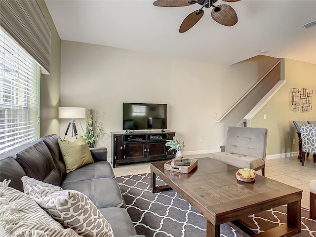 tiled living room with ceiling fan