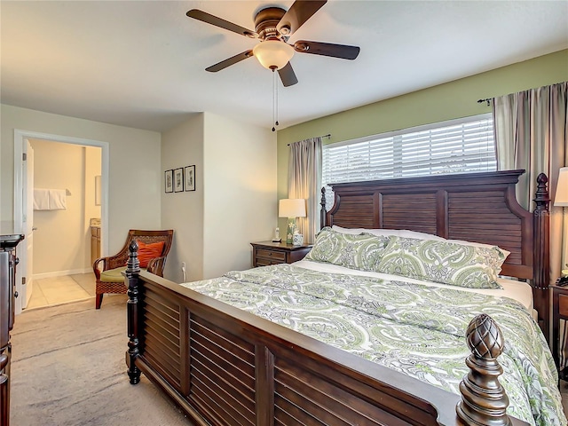 carpeted bedroom featuring connected bathroom and ceiling fan